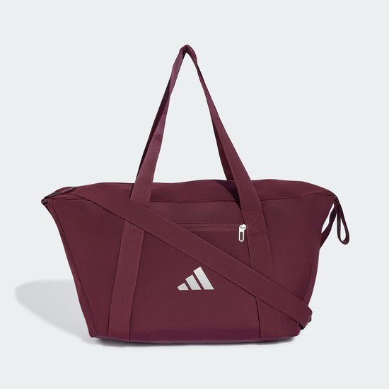 Bordeauxrode sporttas met verstelbare schouderband en wit Adidas logo.