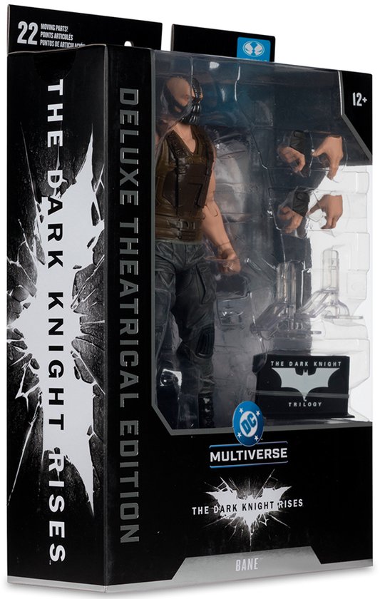Actiefiguur van Bane in verpakking, met masker, bruine vest en grijze broek. "The Dark Knight Rises" logo zichtbaar.