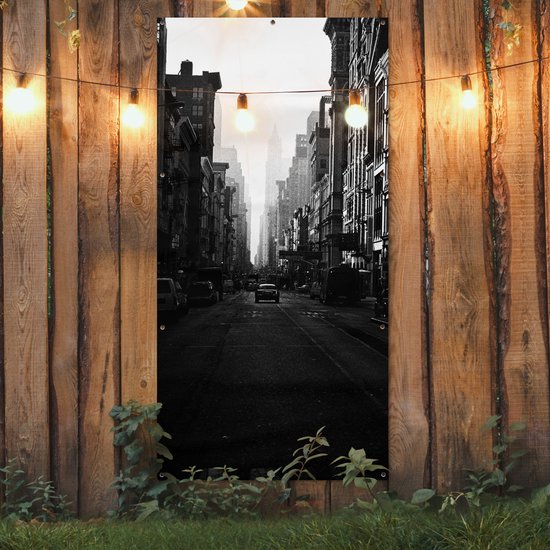Affiche de clôture Une voiture roule dans une rue calme de New York en noir et blanc - 100x200 cm - Toile jardin