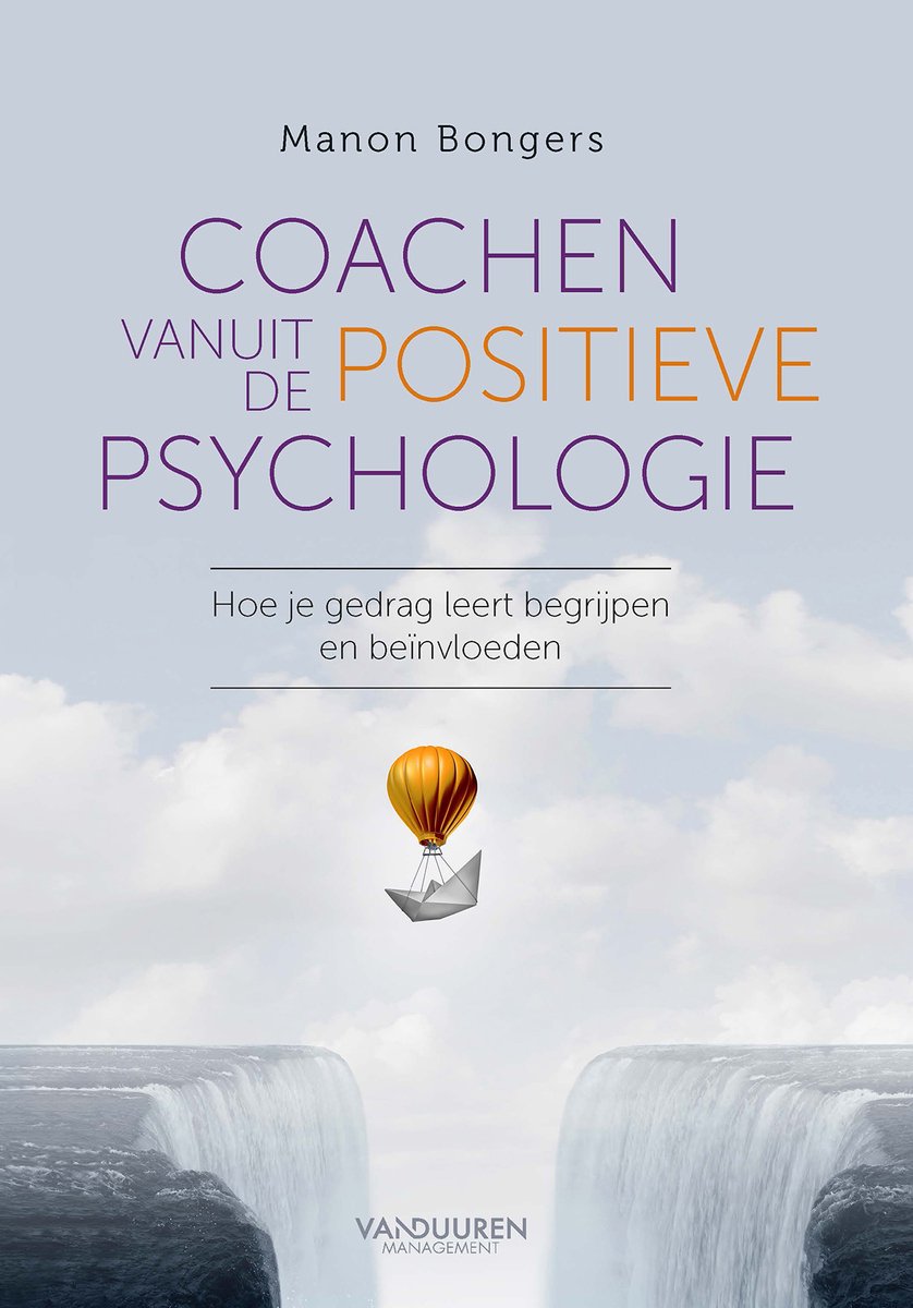 Boek 'Coachen vanuit de positieve psychologie' met een papieren luchtballon boven een ravijn.
