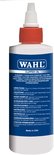 Blauwe fles Wahl tondeuse-olie met rode dop en witte tekst.