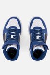 Topview van witte sneakers met blauwe en zwarte PUMA-strepen, blauwe veters en klittenbandsluiting.