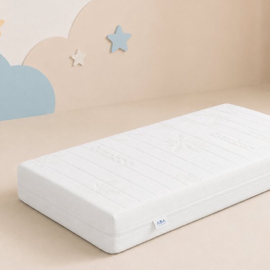 Wit Ada Sleep matras met bamboe-patroon op een beige achtergrond met decoratieve wolken en sterren aan de muur.