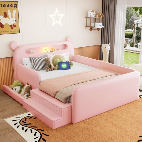 Roze kinderbed opgemaakt met kussens en plaid, met opbergruimte en trap.