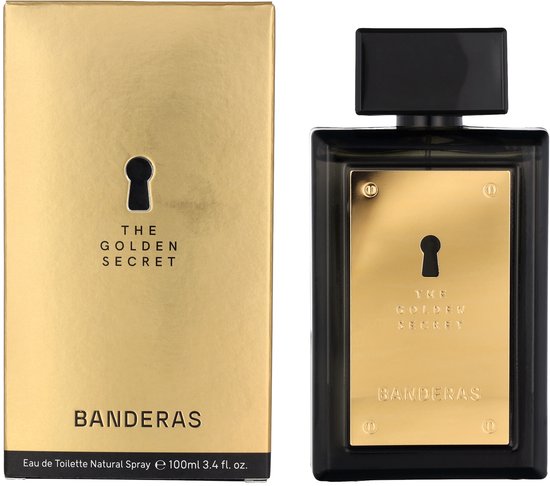 Gouden parfumdoos met sleutelgat en "THE GOLDEN SECRET" en "BANDERAS". Naast de zwarte fles met goudkleurig label met sleutelgat.