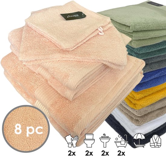 Un ensemble de serviettes vieux rose de différentes tailles, avec une pile d'autres couleurs en arrière-plan.