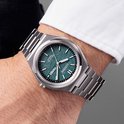 Man met een zilverkleurig Citizen Eco-Drive Titanium horloge met blauwgroene wijzerplaat.
