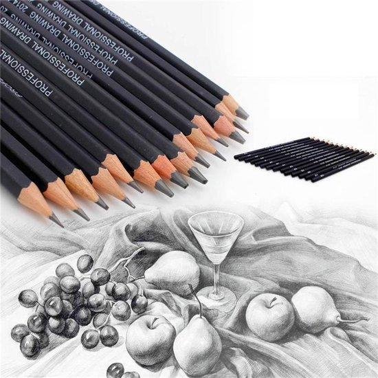 Gros plan de crayons noirs Kasimir, avec un dessin de fruits au crayon en arrière-plan.