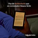 Hand houdt een Kobo e-reader vast in het donker. Tekst op het scherm is helder, met tekstaanpassing voor blauw licht.