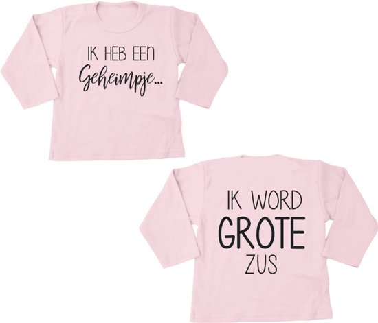 T-shirt rose pâle à manches longues avec inscription "J'ai un secret..." sur le devant et "JE VAIS ÊTRE GRANDE SOEUR" au dos.