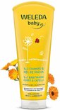 Gele Weleda baby 2-in-1 shampoo en douchegel met witte dop, met illustraties van bloem, lieveheersbeestje en vlinder.