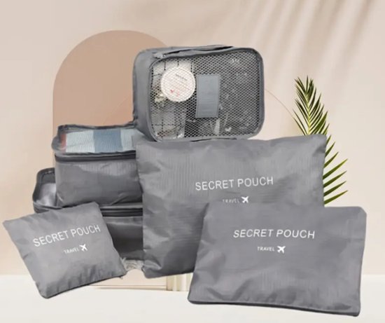 Set van zes grijze packing cubes, waaronder een met gaas en diverse effen modellen met 'Secret Pouch'.