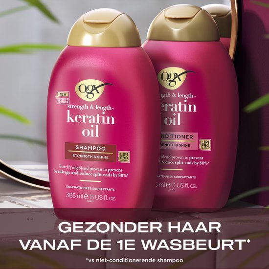 Twee roze OGX flessen met gouden dop, "Shampoo" en "Conditioner". Vertaalde tekst: "Gezonder haar vanaf de 1e wasbeurt*".