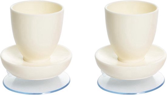 Twee witte eierdopjes met zuignap, om te voorkomen dat ze schuiven.