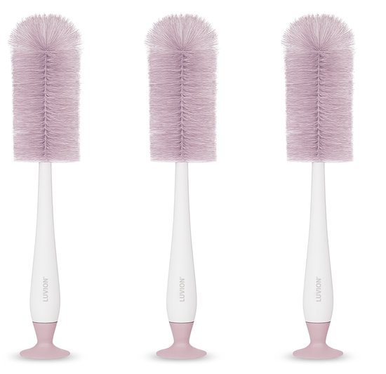 Trois brosses à biberon roses avec manche blanc et base ronde, avec logo LUVION.