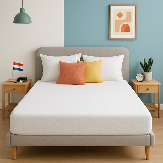 Un drap-housse blanc en tissu éponge dressé sur un lit avec deux tables de chevet, une plante et une décoration.