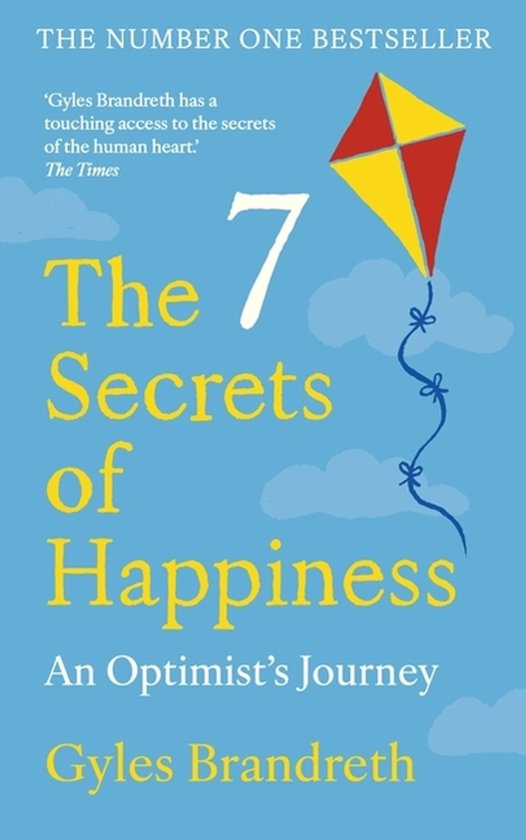 Boek 'The 7 Secrets of Happiness' van Gyles Brandreth, met een vlieger en de tekst 'An Optimist's Journey'.