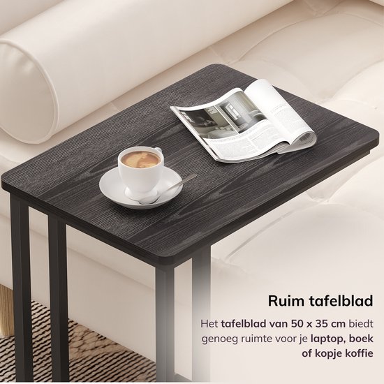 Ruim zwart tafelblad met houtnerf, 50 x 35 cm, met een kopje koffie en een tijdschrift.