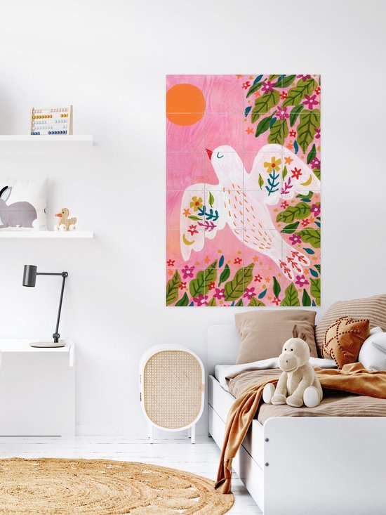 Wanddecoratie met vogelillustratie boven een kinderbed in een slaapkamer.