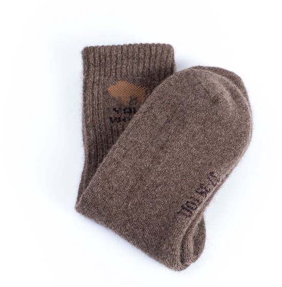 Paar bruine wollen sokken, met opdruk van een bizon en 'WAK WOOL' op de schacht.