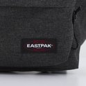 Close-up van het rode Eastpak logo op een donkergrijze rugzak in denimlook.
