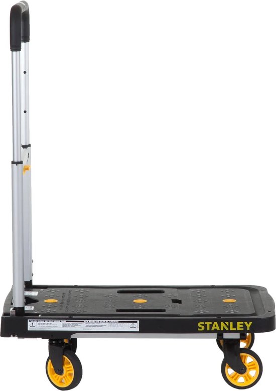 Zijaanzicht van een zwarte Stanley platte handwagen met aluminium handvat en gele wielen.