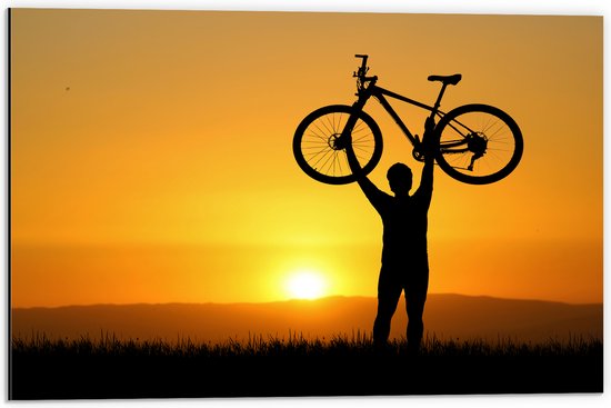 WallClassics - Dibond - Silhouet van Man met Fiets bove Hoofd bij Feloranje Zonsondergang - 60x40 cm Foto op Aluminium (Met Ophangsysteem)