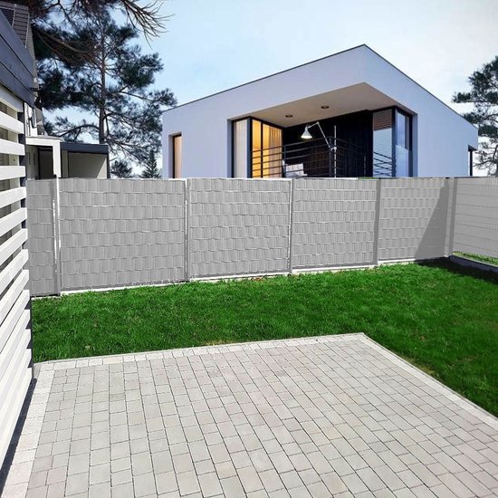 Grijze vlechtband die op een modern hek is aangebracht, met een huis en tuin op de achtergrond.
