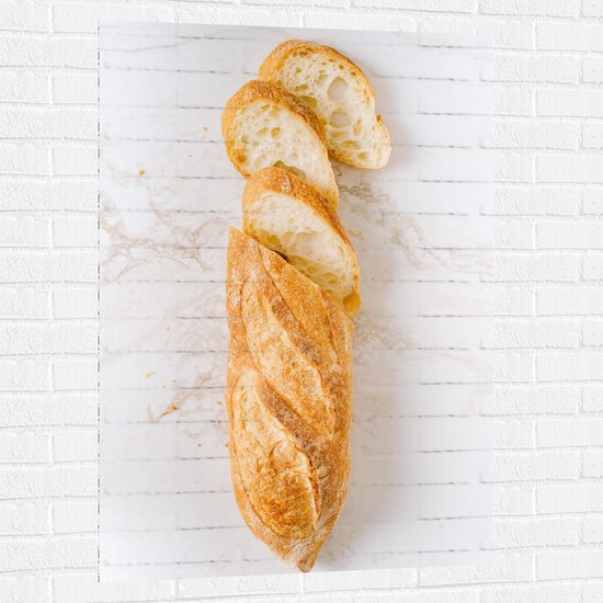 WallClassics - Muursticker - Half Gesneden Stokbrood op Marmeren Ondergrond - 80x120 cm Foto op Muursticker