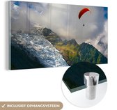 MuchoWow® Glasschilderij 120x60 cm - Schilderij acrylglas - Alpen - Paragliding - Sneeuw - Foto op glas - Schilderijen