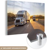 MuchoWow® Glasschilderij 120x80 cm - Schilderij acrylglas - Twee vrachtwagens met een zonsondergang - Foto op glas - Schilderijen