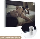 MuchoWow® Glasschilderij 180x120 cm - Schilderij acrylglas - Jonge Aziatische vrouw in lingerie in bed - Foto op glas - Schilderijen