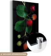 MuchoWow® Glasschilderij 120x180 cm - Schilderij acrylglas - Een aardbeienplant op een zwarte achtergrond - Foto op glas - Schilderijen