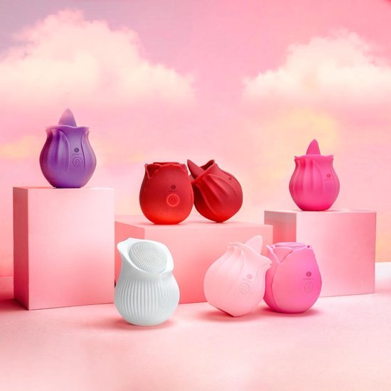 Collectie van roze, paarse en rode tulpenvibrators op roze blokken met roze lucht.