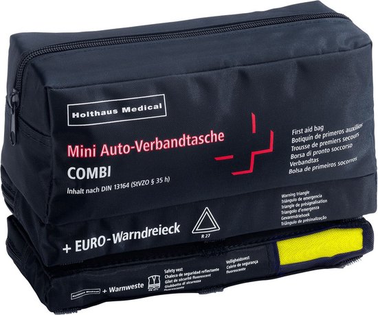 Zwarte stoffen tas met rode opdruk 'Holthaus Medical' en een kruis. Bevat 'Mini Auto-Verbandtas COMBI' en 'EURO-Warndreieck'.