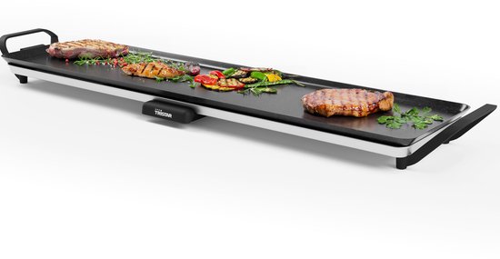 Lange zwarte Tristar grillplaat met gegrild vlees en groenten op een witte achtergrond.