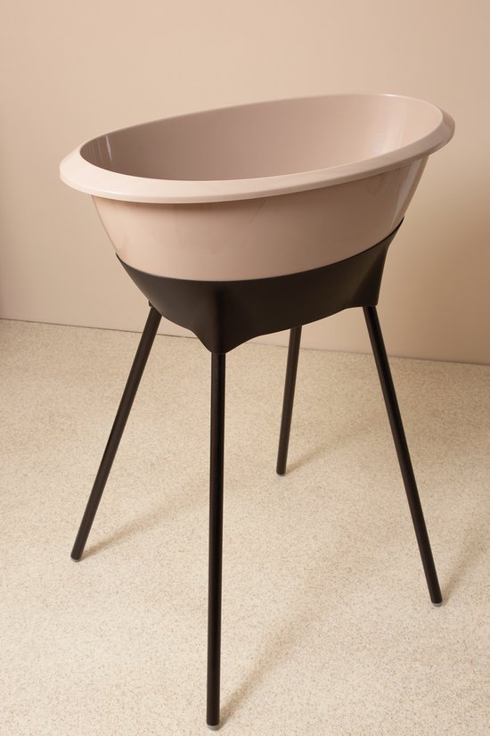 Luma babybadje in beige met een zwart, taps toelopend onderstel.
