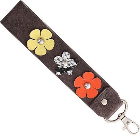 Een fleurige en vrolijke kunstleren sleutelhanger-tassenhanger die ook gebruikt kan worden aan de portemonnee of sleutelbos. De binnenkant heeft een leuke print en de buitenkant is voorzien van fleurige bloemen. Voor uzelf of Bestel Een Kado