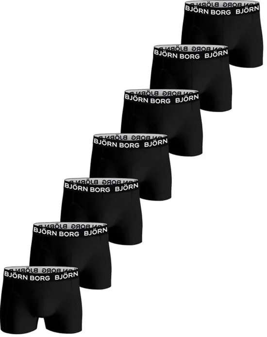 Zeven zwarte boxershorts van Björn Borg met witte merkletters op de elastische band.