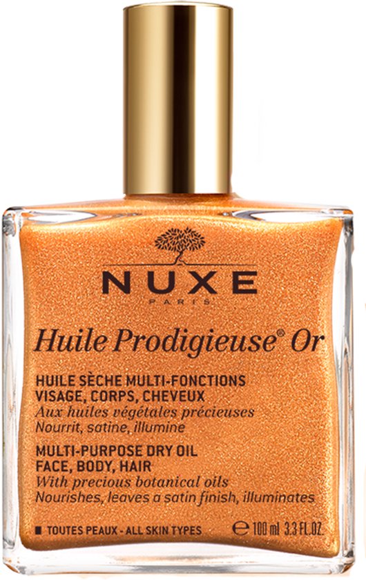 Glanzende goudkleurige Nuxe Huile Prodigieuse Or in een glazen fles met gouden dop. De olie bevat glitters.