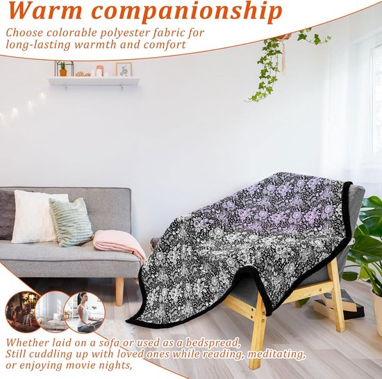 Een met bloemenmotief bedekte deken op een fauteuil. Zwart met witte bloemen, met subtiele paarse gloed. Zwarte pluizige rand.