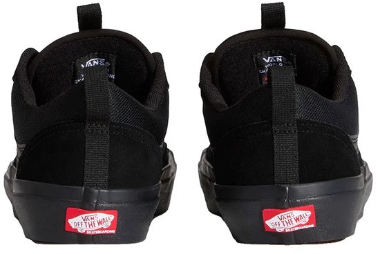 Achterkant van twee zwarte Vans Old Skool sneakers, met rode 'Vans Off The Wall' logo's op de zool.