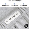 Close-up van het grijze katoen van een pyjama met het label 'Dore & Rose' en OEKO-TEX logo.