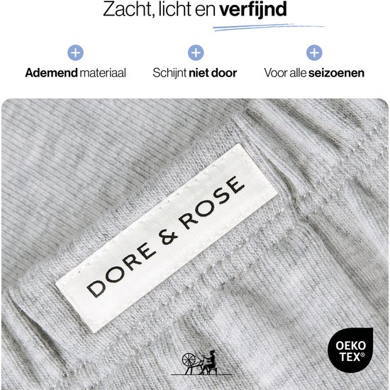 Close-up van het grijze katoen van een pyjama met het label 'Dore & Rose' en OEKO-TEX logo.