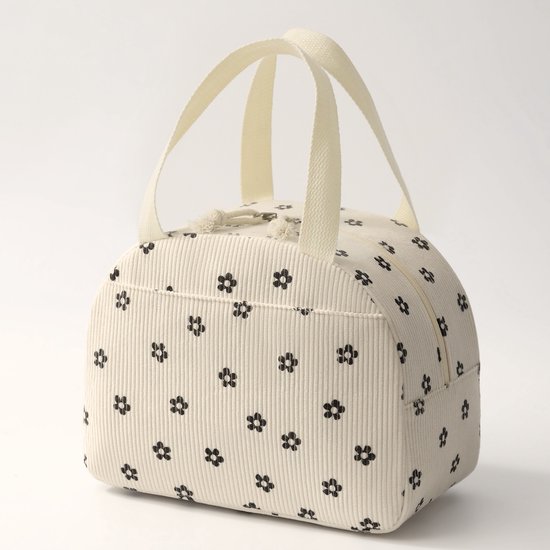 Sac à lunch beige en velours côtelé à petite fleur noire, modèle debout.