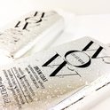 Twee zilverkleurige flessen met "WOW" logo en "DREAM COAT SUPERNATURAL SPRAY", bedekt met waterdruppels.