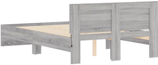 Achterkant van een grijs eiken houten bedframe met hoofdeinde en houten lattenbodem.