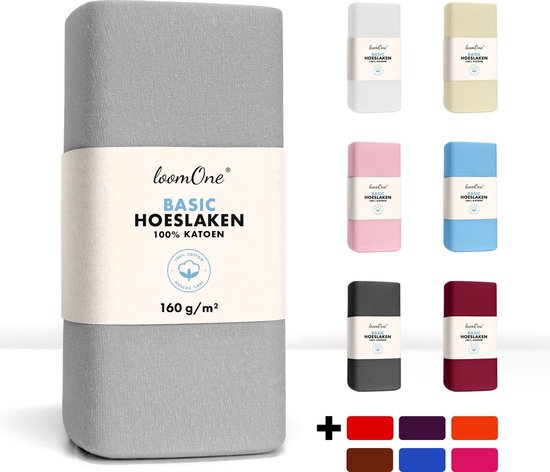 Drap-housse pour topper gris plié avec étiquette 'loom One BASIC HOESLAKEN 100% KATOEN 160 g/m²' et un collage d'autres draps-housses de couleur.