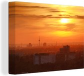 Canvas Schilderij De ondergaande zon boven de skyline van het Duitse Mannheim - 120x90 cm - Wanddecoratie