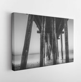 Canvas schilderij - An early morning view of the ethereal waves crashing into the pier support legs.  -     1538505320 - 40*30 Horizontal